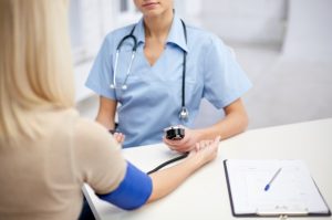 nurse taking a blood pressure reading